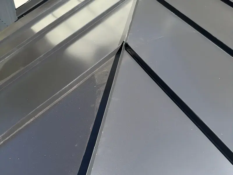 Black standing seam metal porch roof valley detail in NC