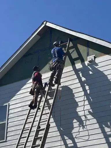 Siding crew repairing gable in Raleigh NC