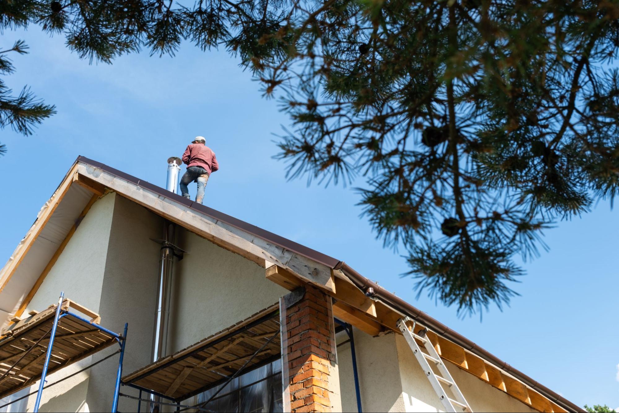 Construction worker standing on a roof. 
