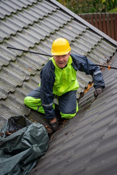 Roofing contractor installing roof on residential home in NC