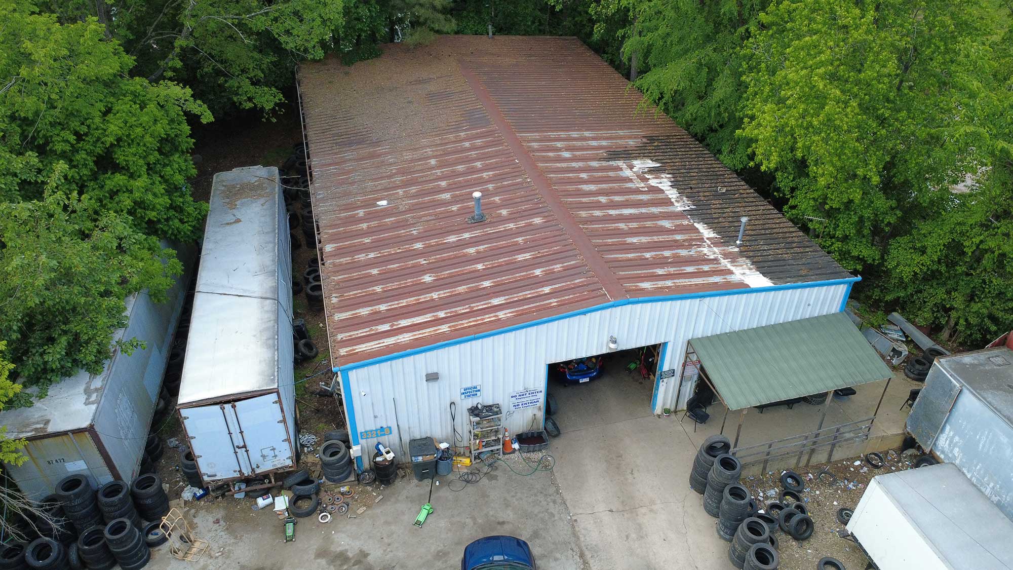 Aerial shot of a building with a prominent roof, emphasizing its architectural style and context in the area.