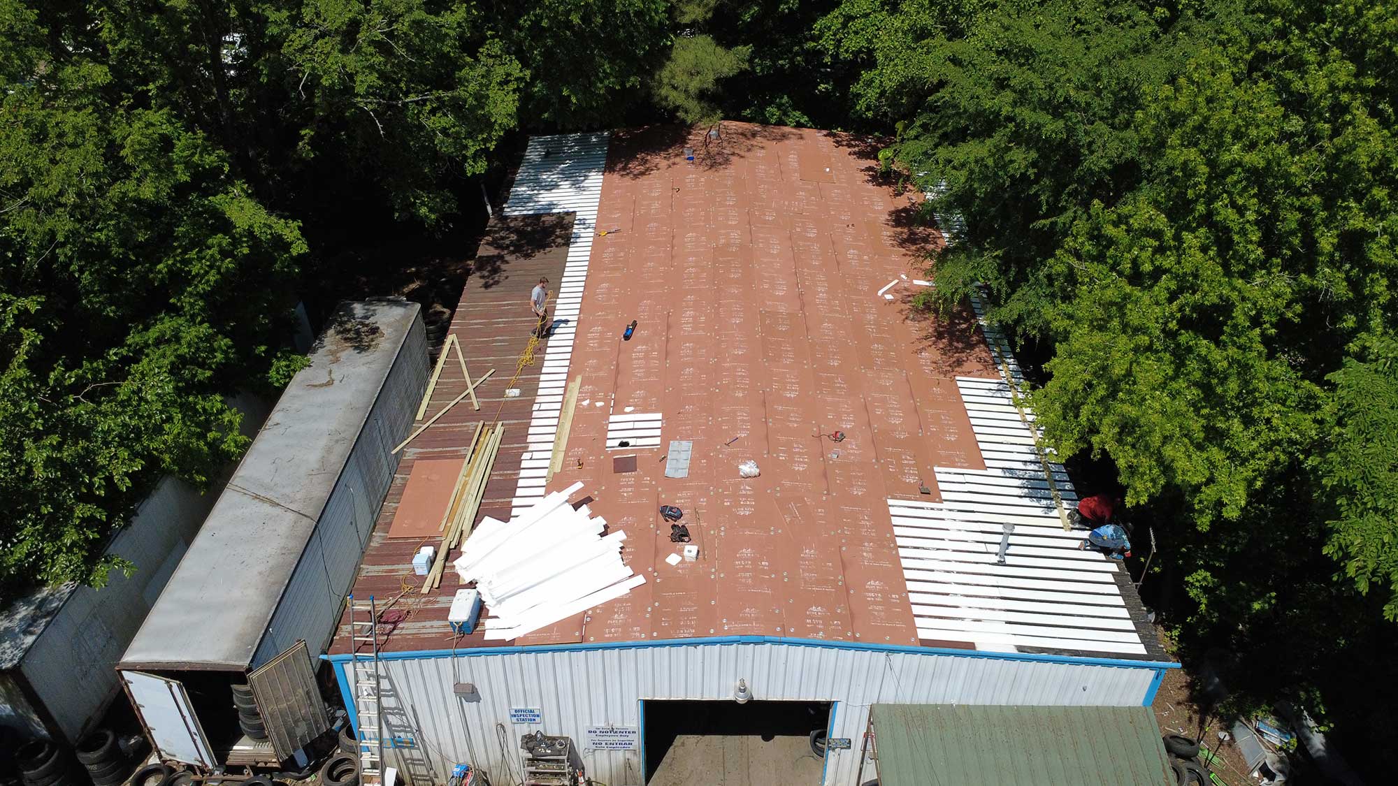 Overhead perspective of a building with a distinct roof, illustrating its design and placement within the environment.