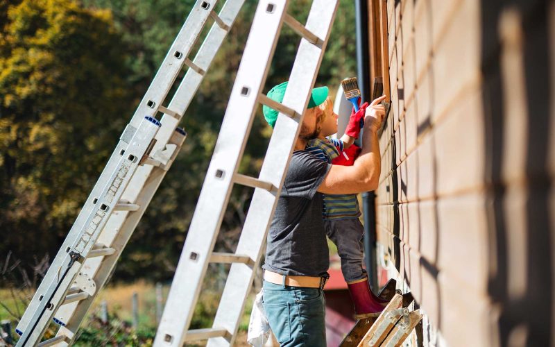 a-father-and-toddler-boy-outdoors-in-summer-paint