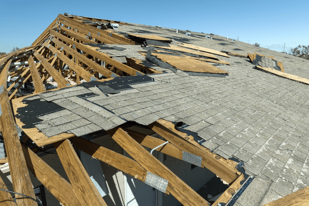 A damaged roof with missing shingles.