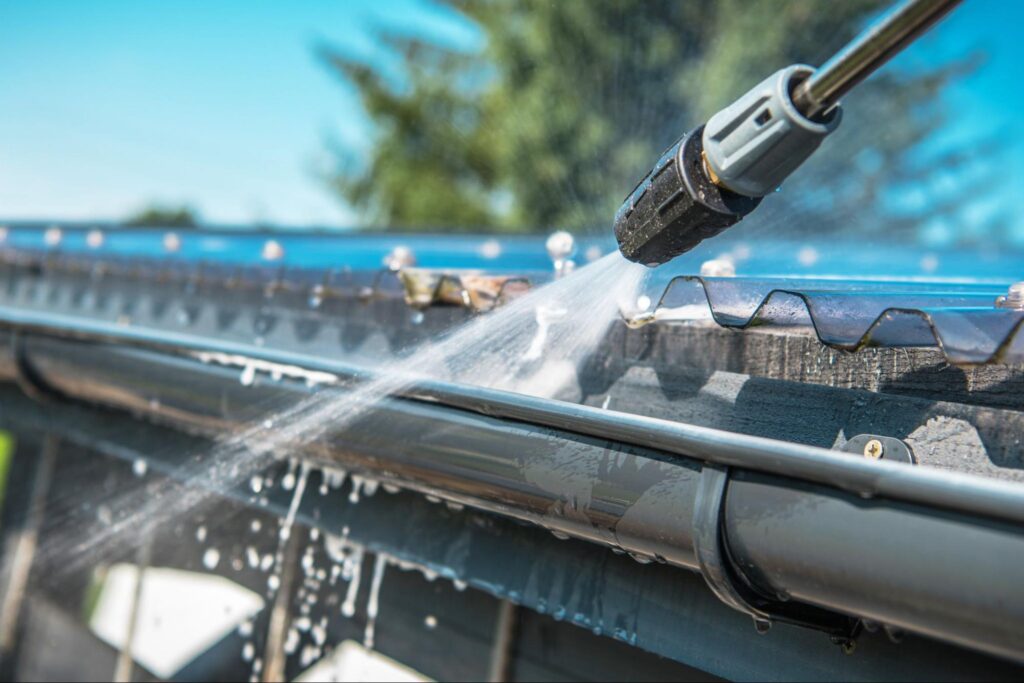 Close-up shot of rain gutter pressure washing during service.