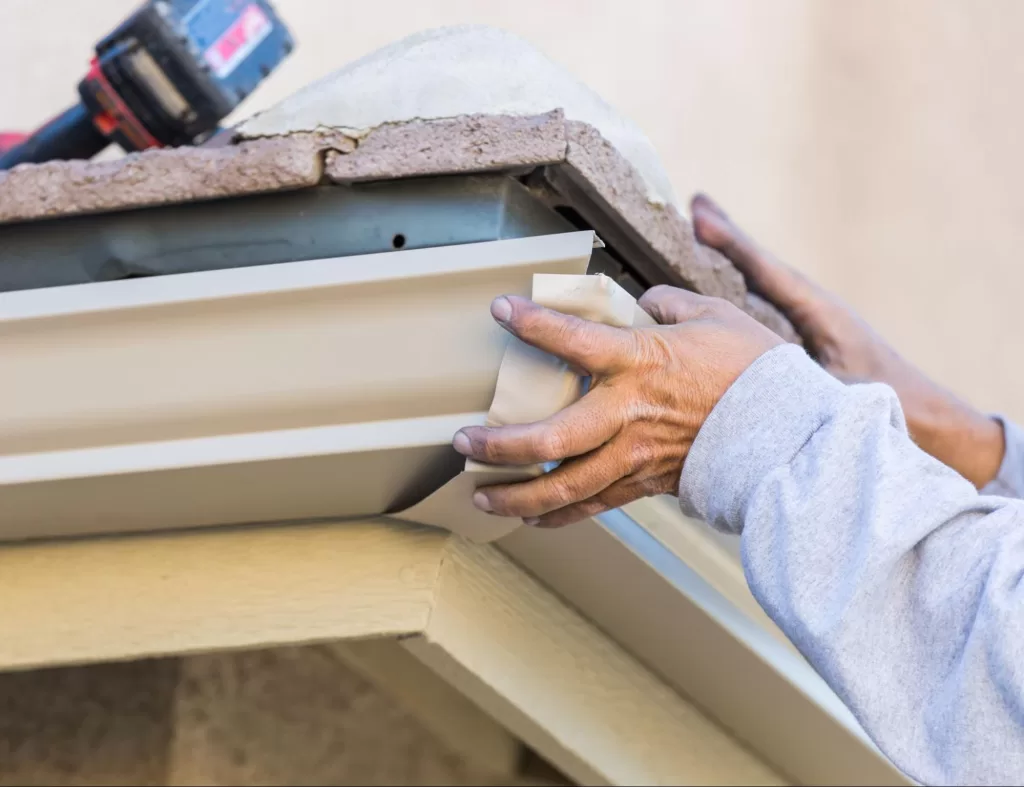 A close-up view of rain gutter installation.